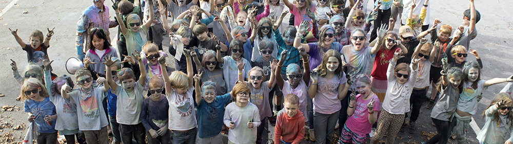 children stand together after participating in a color run
