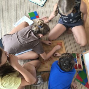 students work on Montessori math materials